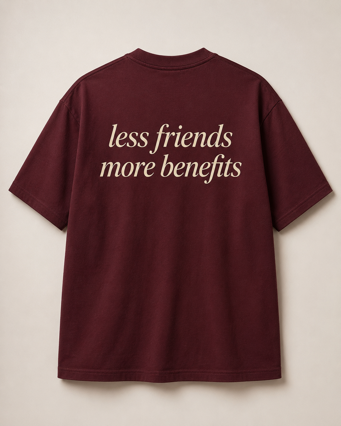 Back of burgundy SORRY BABY shirt reading less friends more benefits in lowercase serif italic