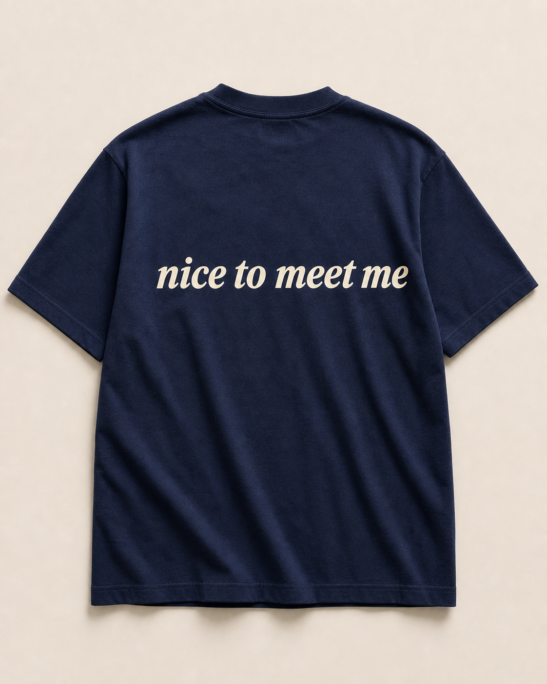 Back of navy SORRY BABY shirt reading nice to meet me in lowercase serif italic