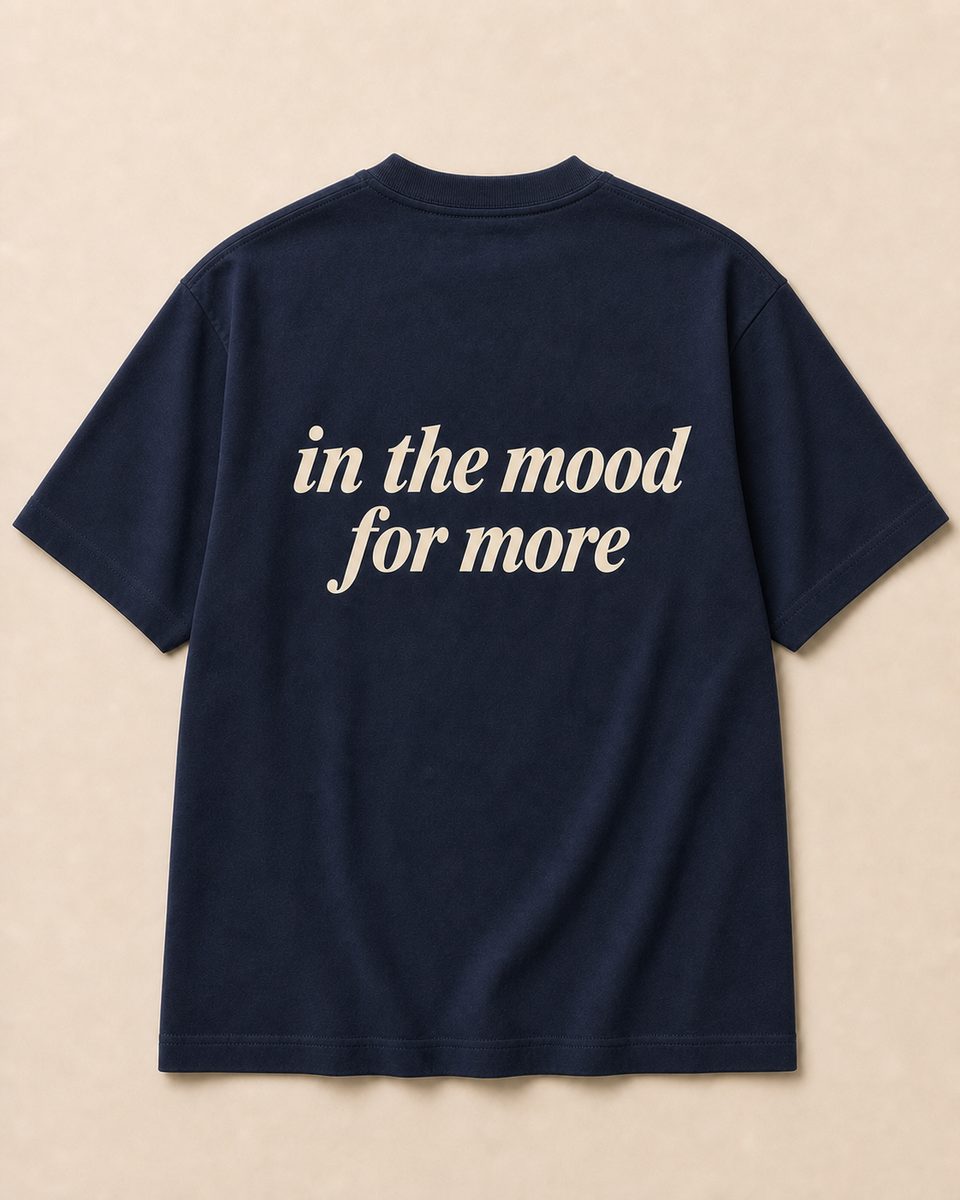 Back of navy SORRY BABY shirt reading in the mood for more in lowercase serif italic