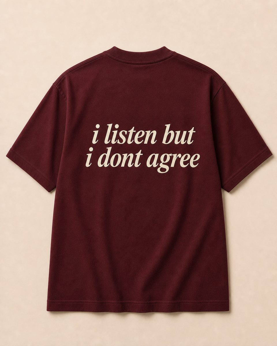 Back of burgundy SORRY BABY shirt reading i listen but i dont agree in lowercase serif italic