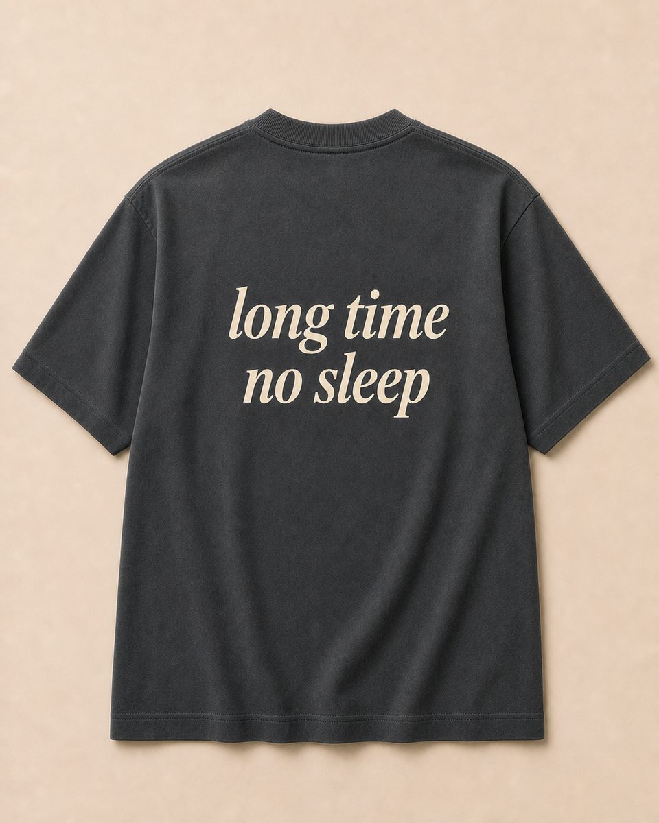 Back of charcoal grey SORRY BABY shirt reading long time no sleep in lowercase serif italic